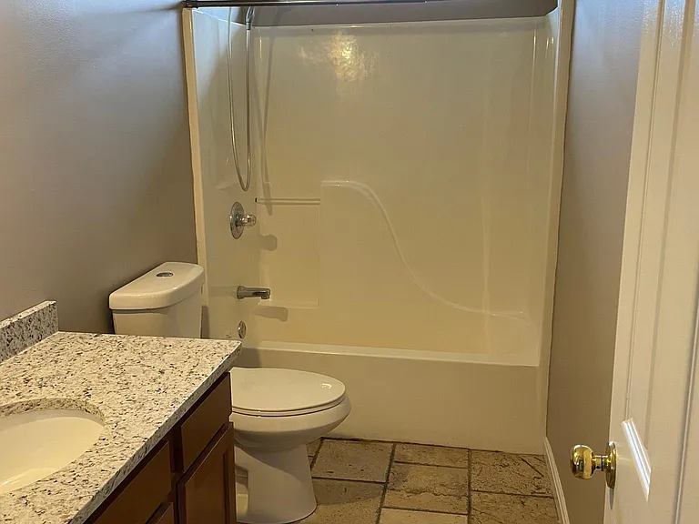 Large bath off of top floor hall serves both upstairs bedrooms. New vanity and granite counter top.