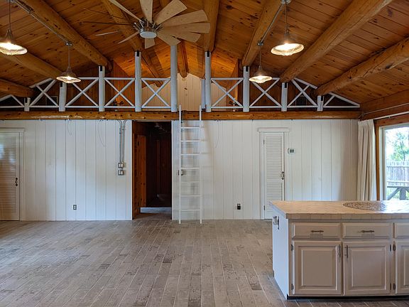 View from the kitchen of dining area and loft upstairs.