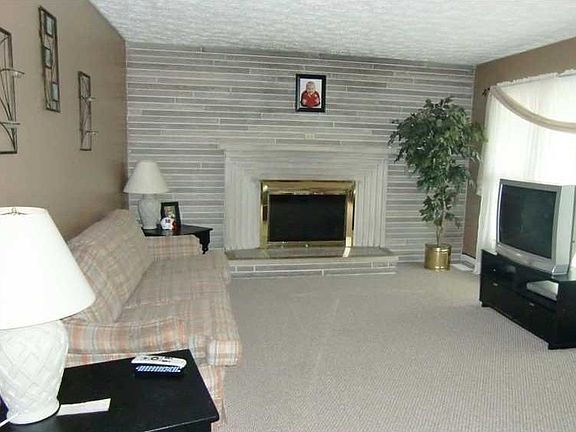 Living Room. Second view of living room.  Note full wall stone fireplace.