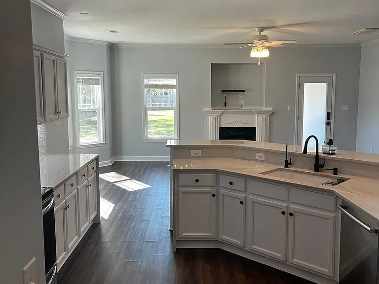 Open view from the kitchen toward the living room, highlighting the spacious connected layout.