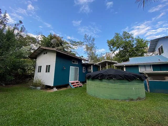 Tiny house, with its own private entrances, is attached to main house by decks. Privacy between the main house and the tiny house is created with bamboo screens.