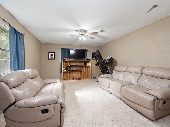 Gather the family and guests together in your lovely living room. Featuring high ceilings, modern ceiling fan, custom paint, thick carpet, and large windows that provide plenty of natural lighting throughout the day!