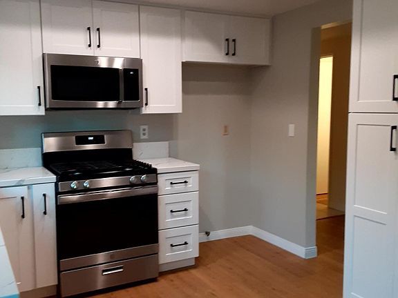 Appliances microwave gas stove refrigerator area