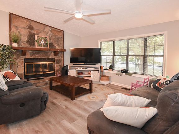 Working Fireplace for Cozy Evenings, Bay Window lets in the Light and new LVP Flooring is beautiful and easy to maintain in oversized family room with Vaulted ceilings.