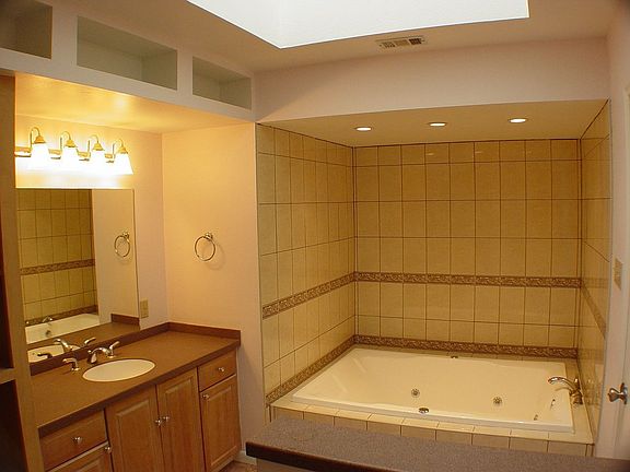 Master bath features a skylight and double sized spa tub.
