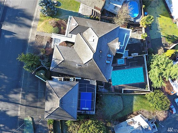 Oh, did I forget to mention the huge in-ground pool, hot tub, sport court & slate patio with built-in BBQ? This home has it all.