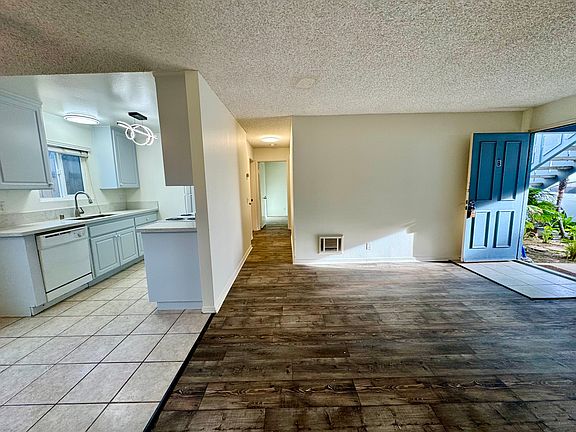 View from living room into kitchen and hallway to bedrooms