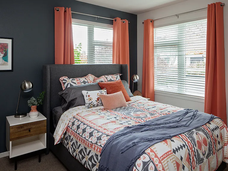 Grant park village shot of bed with orange curtains