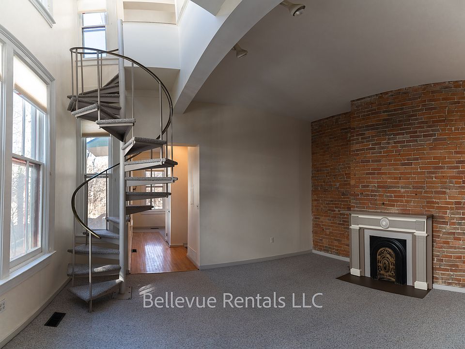 living room with spiral stairs