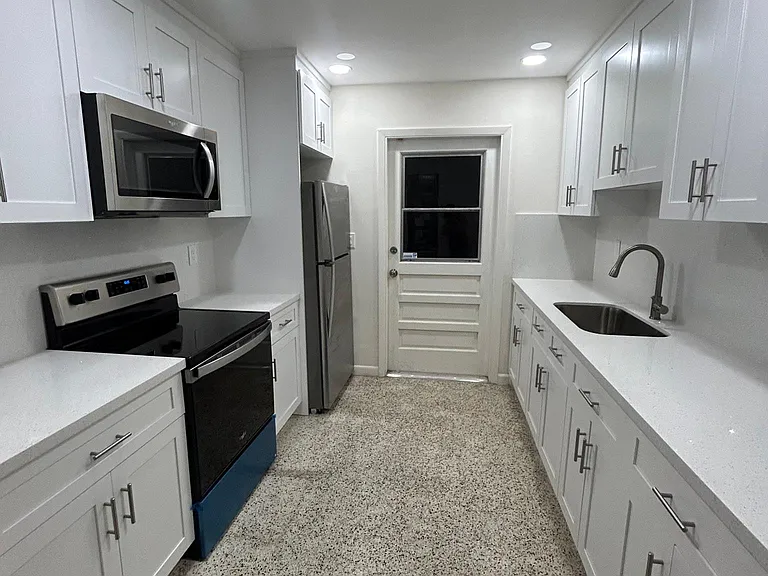 Completely redone with quartz countertop and cabinets all the way up.