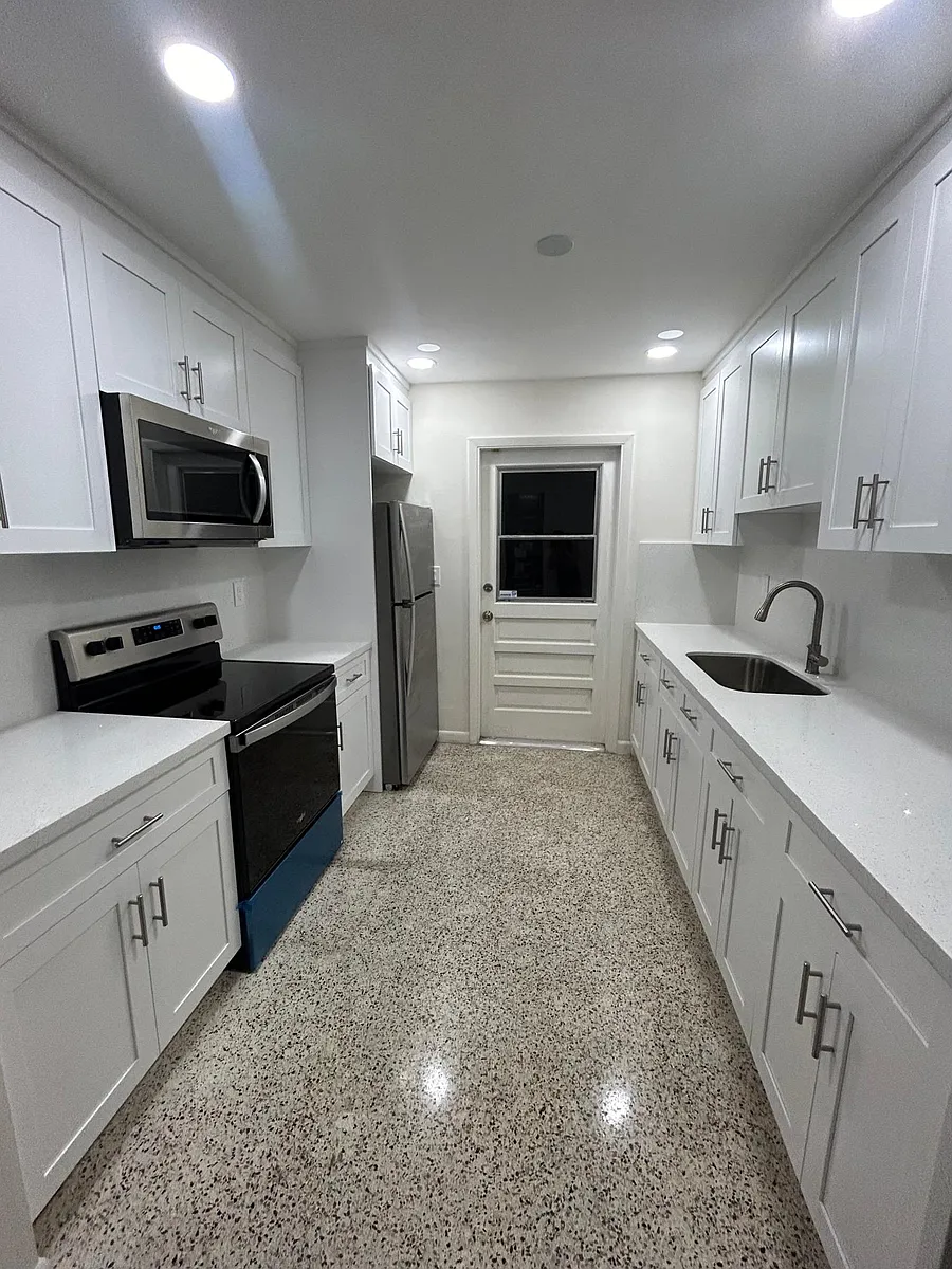 Completely redone with quartz countertop and cabinets all the way up. - 9525 SW 45th Ter