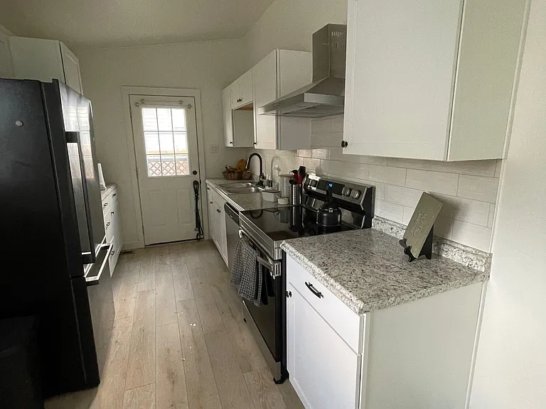 current kitchen, black refrigerator included with rental