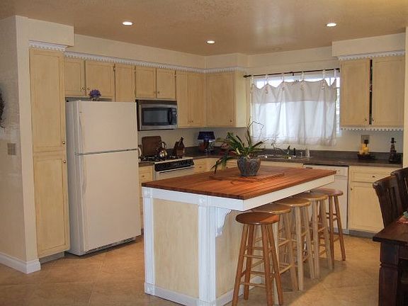 Kitchen with custom island with butcher block top