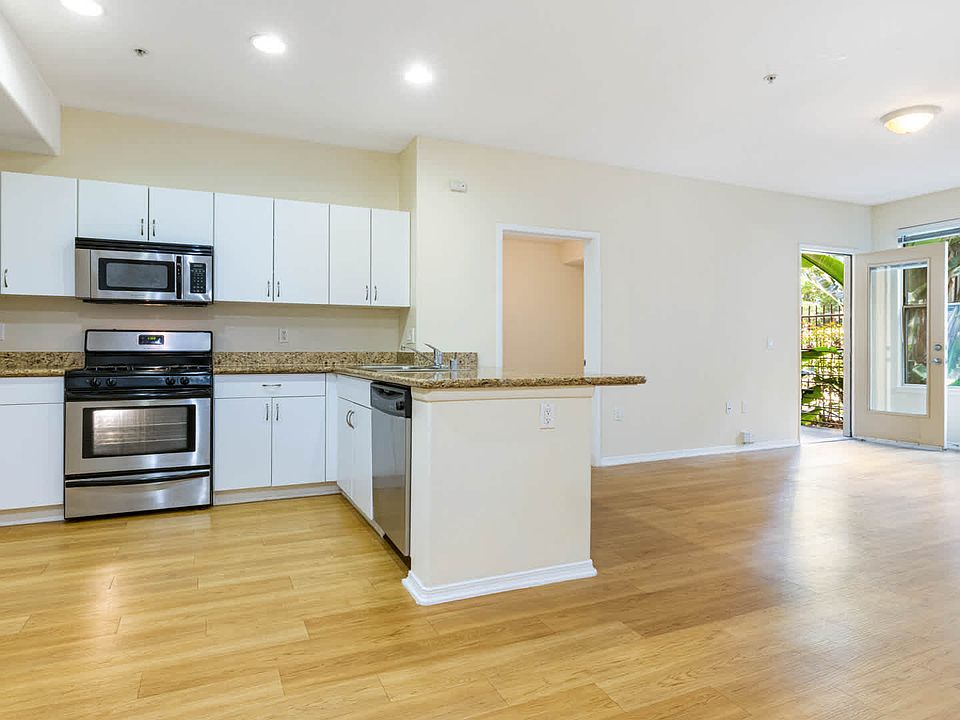 Kitchen with Stainless Steel Appliances and Living Room with Hard Surface Flooring