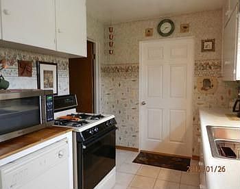 Kitchen includes refrigerator & gas range