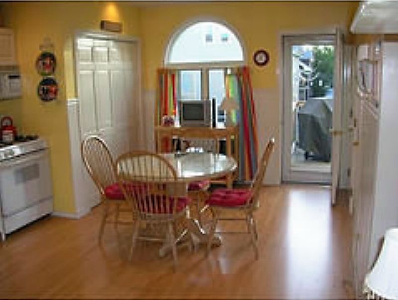 Kitchen with access to porch, backyard and laundry (behind d