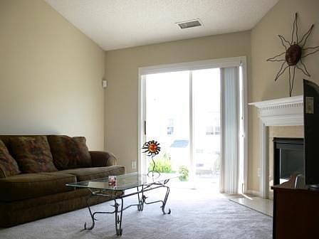 Great room with vaulted ceiling, marble fireplace, and gas logs