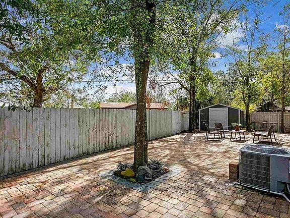 Private, fenced-in back patio with paver brick