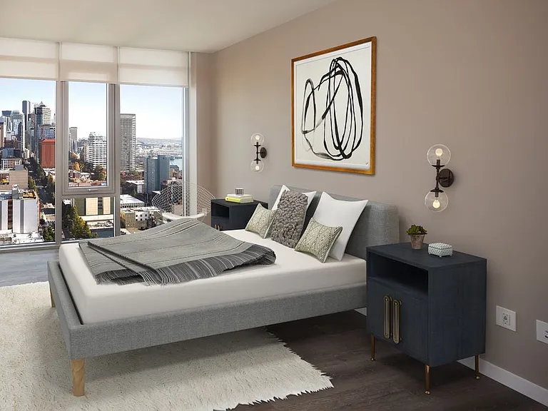 Signature Collection penthouse bedroom with floor-to-ceiling windows and hard surface flooring.