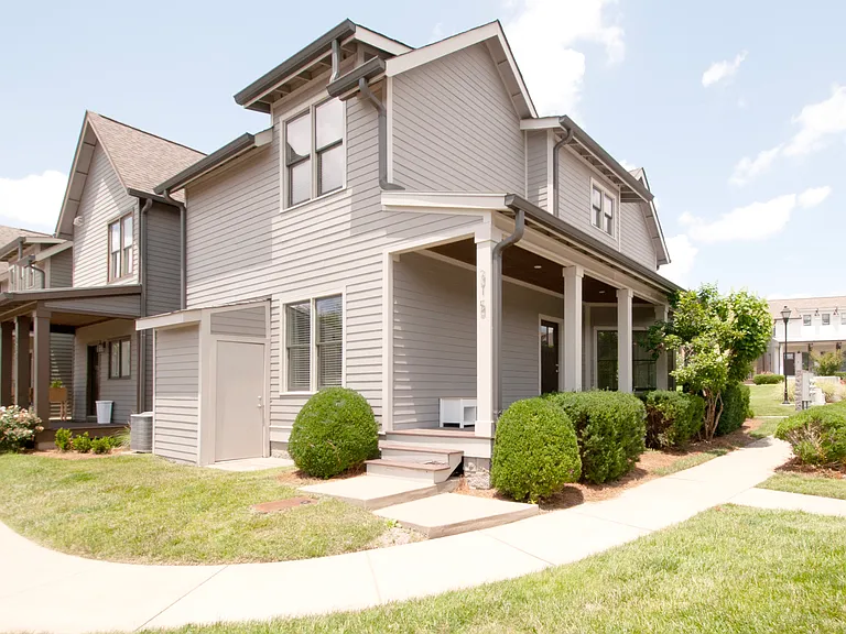 View of the back of the house showing the porch to the side door and the exterior storage closet