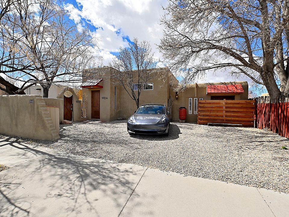 Front View showing parking area, rental front door, owner front access gate and private, fenced patio with huge, ash, shade tree.