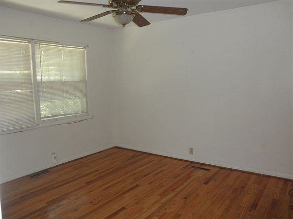 Bedroom with hardwood & ceiling fan