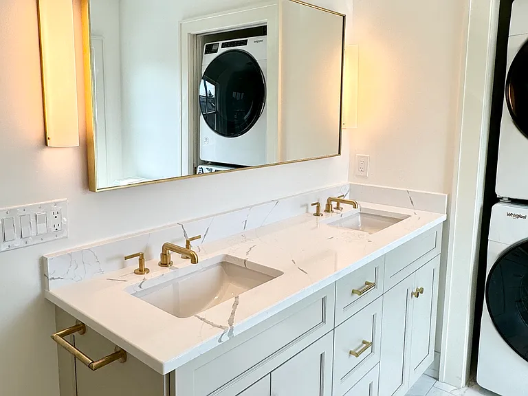 Master bathroom with walk-in shower and front-load washer/dryer