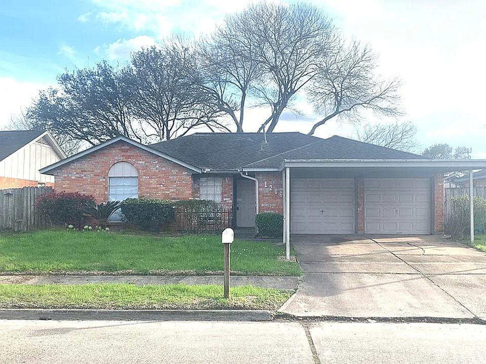 Solid brick home with 2-car Garage and covered driveway.