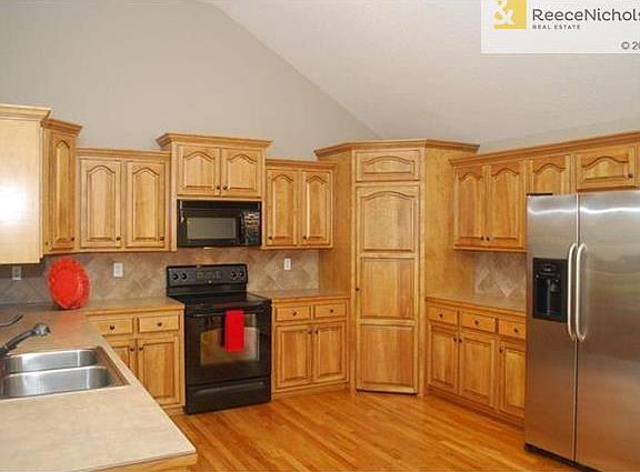 So many beautifully stained cabinets, and a walk-in pantry.  Your friends will envy all the storage space.