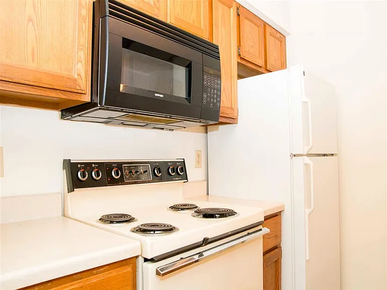 Classic and reliablethis kitchen includes essential appliances like an electric stove, microwave, and full-size fridge to cover your everyday cooking needs.