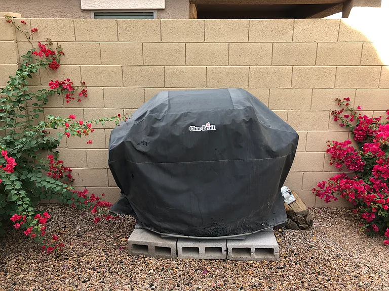 Grill in the backyard with grill cover