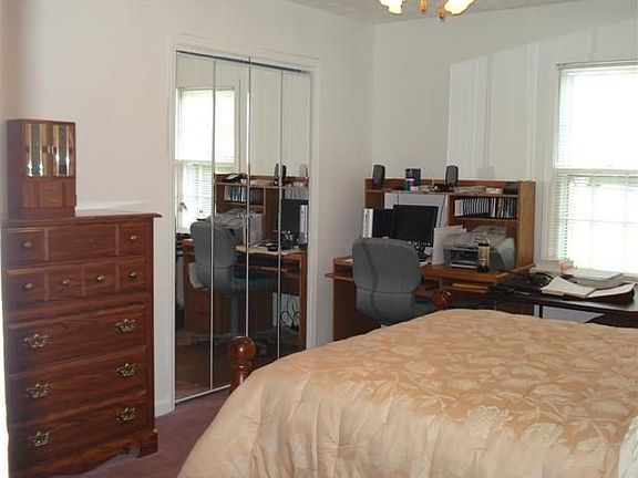 Master closet with mirrored doors.  Room for small desk as well as accessories