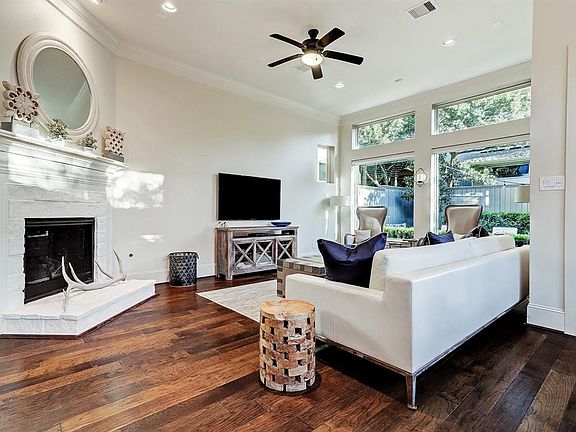 High ceilings, warm hardwood flooring and a beautiful fireplace and mantel are perfect to unwind and enjoy.
