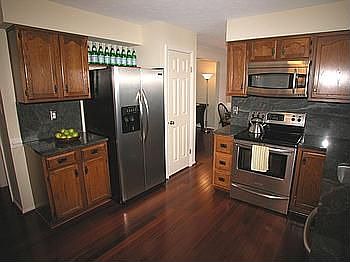 Kitchen with slab granite and new stainless appliances