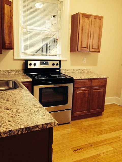 Wrap around cherry kitchen with stainless steel appliances