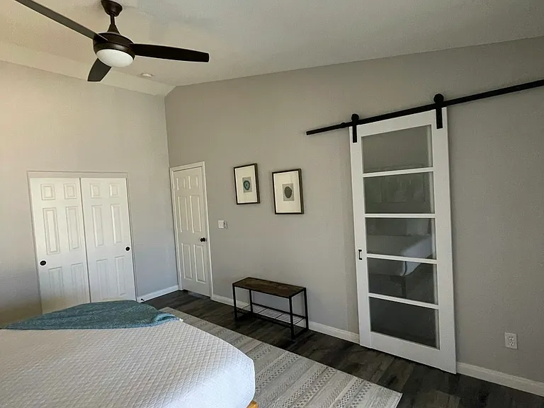 Primary suite with new barn door to bathroom
