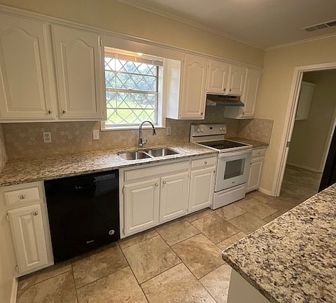 New granite counter tops, back splash, and freshly painted cabinets and walls make this kitchen feel bright and welcoming!