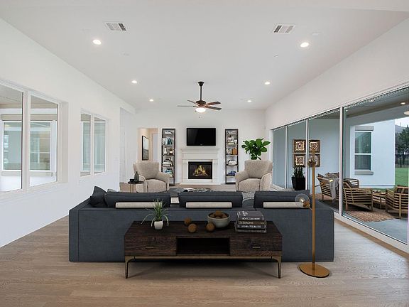 Great room with views to courtyard and covered back porch, virtually staged for demonstration