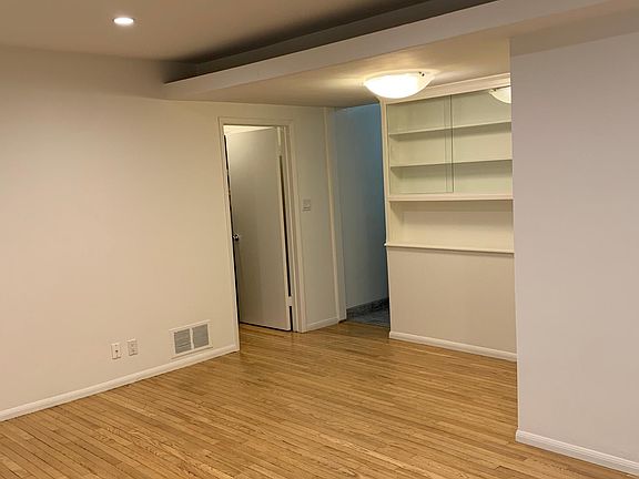 hardwood floors, recessed light, built-in bookshelves
