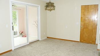 Dining room, that leads to the three season room, leading out to the deck.