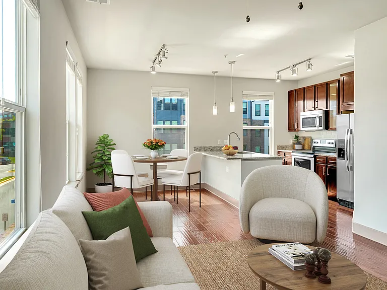 A modern living room with a white couch and a coffee table.
