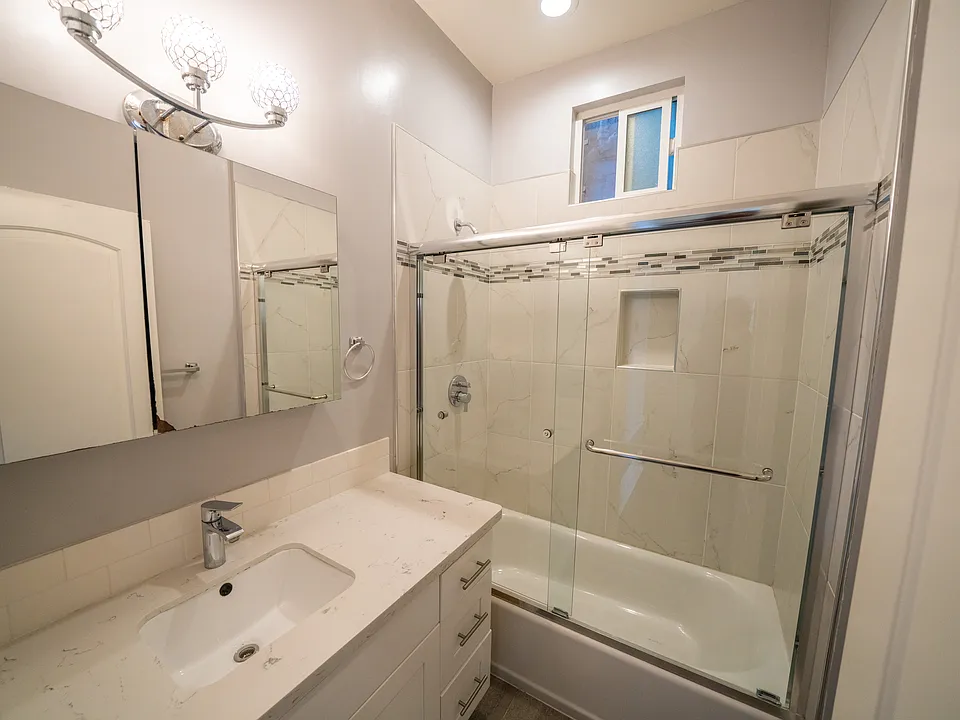 Modern bathroom with German fixtures and auto temp. sensing shower, ventilation fan, window and much more.