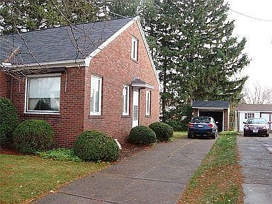 South side of house and one car garage with automatic garage door opener and electrical outlets