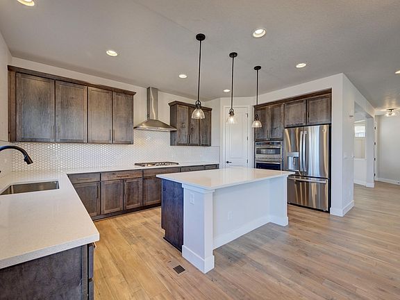 Gourmet kitchen with pantry and many cabinetry.