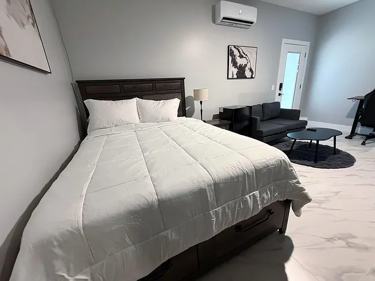 Split A/C for personalized temperature control, small living area with love seat, coffee table, TV and entertainment center