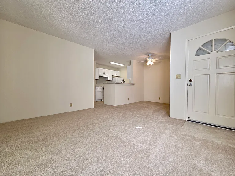 Living Room with Window AC and New Carpet