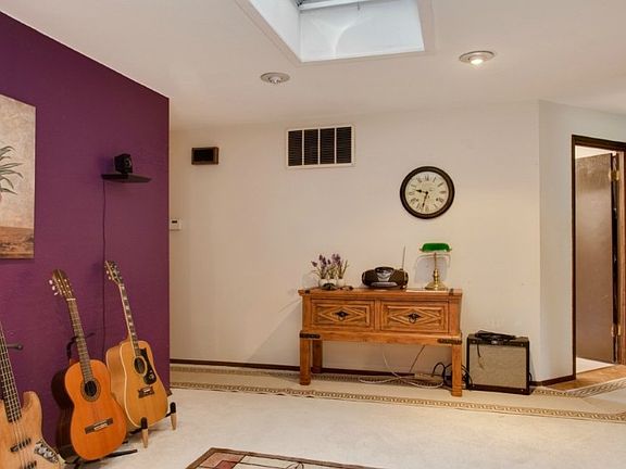 Large dining area with skylight opens to living space...currently being used as a music room.