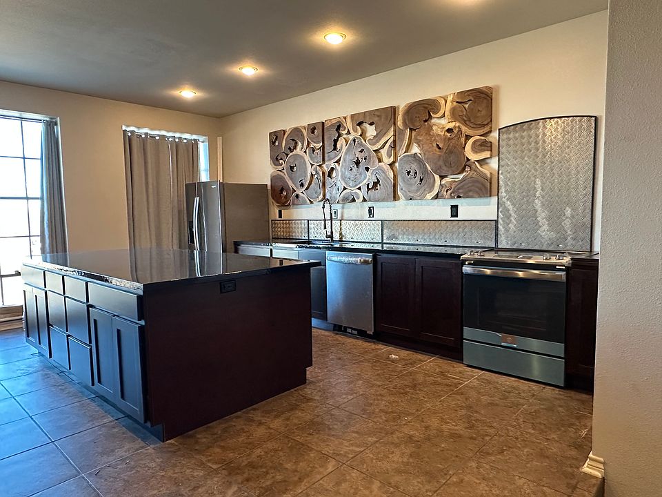 New cabinetry, epoxy countertops, appliances in kitchen. Repurposed diamond plate aluminum from wind turbines for the backsplash.