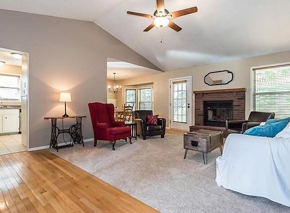 Living Room View From the Front Door-wood floors, new carpet, new ceiling fan, fireplace and fresh neutral paint