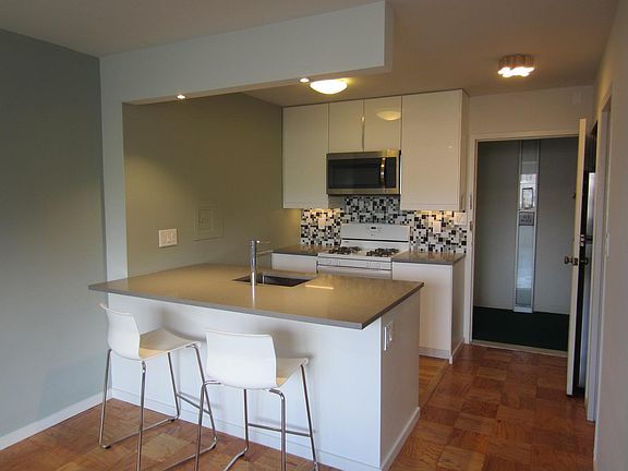 Open kitchen with bar counter & stools
